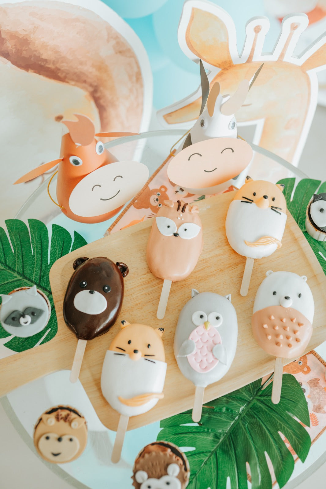A colorful table displaying various animal-themed popsicles in fun shapes and vibrant colors.